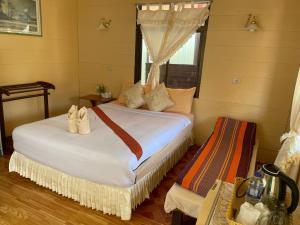 a bedroom with two beds and a window at Starlight Haadrin Resort in Haad Rin