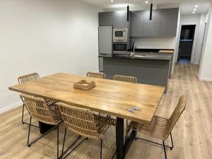 a dining room table with chairs and a kitchen at Guggenheim in Bilbao +8 photos
