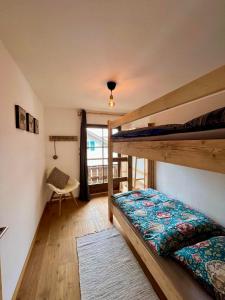 a bedroom with two bunk beds and a window at Chalet Alpenflair in Pfronten