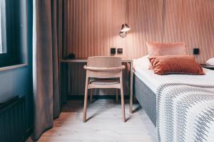 a bedroom with a desk and a chair next to a bed at Centro Hotel Turku in Turku