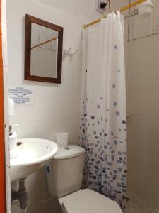 a bathroom with a toilet and a sink and a shower at Hospedaje Campestre El Rancho de Jero in Jardin
