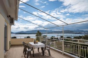 a balcony with a table and chairs and a view of the water at Sea View Volos in Volos