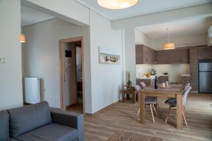 a living room and kitchen with a table and chairs at Sea View Volos in Volos