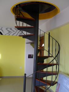a spiral staircase in a room with green walls at la villa de Rose in Kalymnos