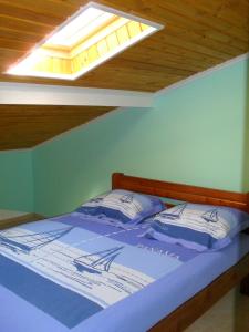 a bedroom with a bed with a skylight at la villa de Rose in Kalymnos