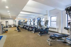 a gym with a row of treadmills and machines at Chelsea 1BR w Gym Concierge nr Penn Stn MSG NYC-439 in New York