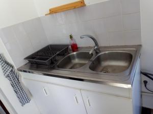 a sink in a kitchen with a stove at Source AUGER in Gruchet-le-Valasse