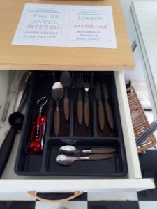 a drawer filled with cooking utensils in a drawer at Source AUGER in Gruchet-le-Valasse
