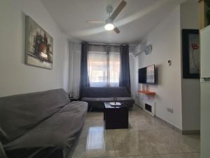 a living room with a couch and a window at Pindarou Apartment in Nicosia