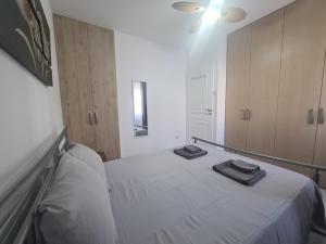 a bedroom with a bed with two towels on it at Pindarou Apartment in Nicosia
