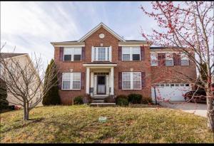 a red brick house with a white garage at Van Gogh Guest Rm #3 • Van Gogh 3-Comfy Private Rm in single family home in Rosedale