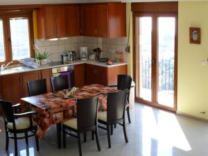 a kitchen with a table and chairs in a kitchen at la villa de Rose in Kalymnos