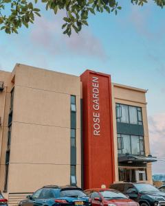 a building with cars parked in front of it at Rose Garden Private Apartment By LINK in Kigali