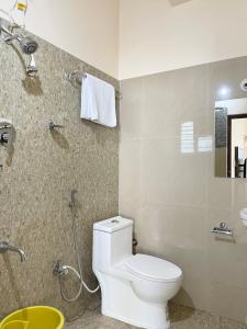 a bathroom with a toilet and a shower at The INN in Mysore