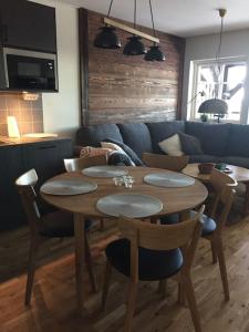 a wooden table and chairs in a living room at Björnrike Vemdalen. Mitt i backen in Vemdalen