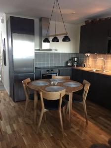 a kitchen with a table and chairs and a refrigerator at Björnrike Vemdalen. Mitt i backen in Vemdalen