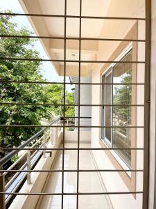 a view from the balcony of a house with large windows at The INN in Mysore