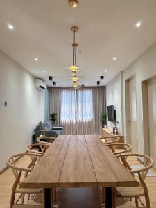 a dining room with a wooden table and chairs at SAMUA Homes (City View, Drawbridge & KTCC Mall) in Kuala Terengganu