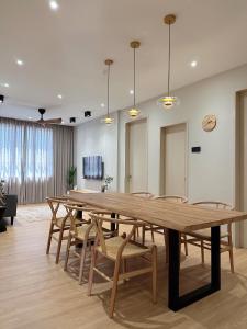 a large wooden table and chairs in a room at SAMUA Homes (City View, Drawbridge & KTCC Mall) in Kuala Terengganu