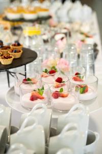 a long table with dishes of dessert on it at Hotel Rozmaryn i Lawenda in Minikowo
