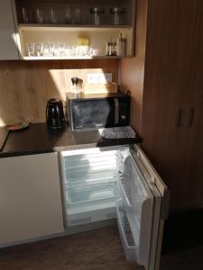 uma pequena cozinha com frigorífico e micro-ondas em APARTMÁNY PIETRO em Oravský Podzámok