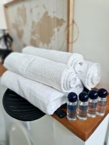 a wooden shelf with towels and bottles of water on it at Maison Cosy en Pleine Nature 