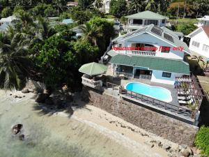 an aerial view of a house on the beach at The Drake Seaside Apartment in Bel Ombre