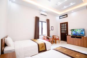 een hotelkamer met een bed en een televisie bij Hồng Ngọc Hotel in Lạng Sơn