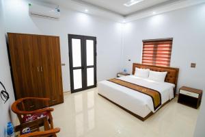 Postel nebo postele na pokoji v ubytování Hồng Ngọc Hotel