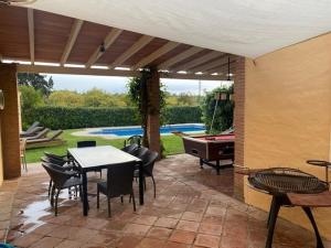 a patio with a table and chairs and a pool at CASA CAMPO in Manilva