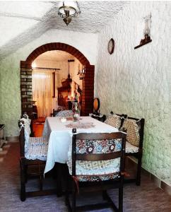 a dining room with a white table and chairs at Sailor's Rustic House in Virpazar