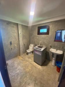 a small bathroom with a toilet and a sink at sunny mound unawatuna close by sri yoga shala in Unawatuna