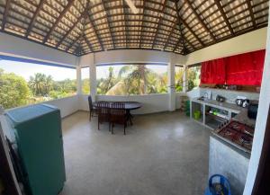 a kitchen and dining room with a table and chairs at sunny mound unawatuna close by sri yoga shala in Unawatuna