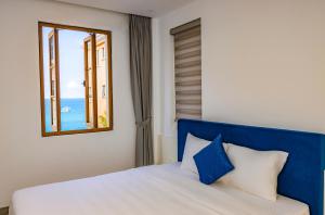 Postel nebo postele na pokoji v ubytování Rose Hotel Phú Quốc