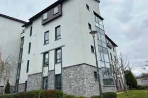 a large white building with windows and a street light at Apartment , Centre Carrick-On-Shannon in Carrick on Shannon