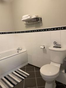 a bathroom with a white toilet and a bath tub at Apartment , Centre Carrick-On-Shannon in Carrick on Shannon