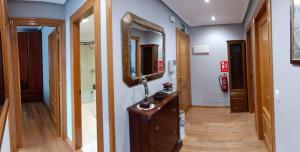 a hallway with a vanity and a mirror at Apartamento Bergantín Habana VuT in Ribadesella
