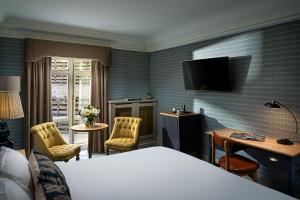 a hotel room with a bed and a television at Schoolhouse Hotel in Dublin