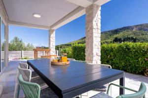 a black table and chairs on a patio with a view at Villa Anouk in Pitve