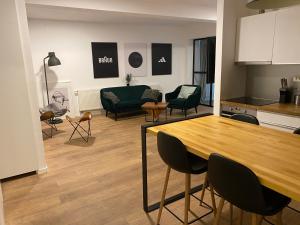 a kitchen and a living room with a table and chairs at Apartment Franky 6 , 1 st Floor in Zagreb