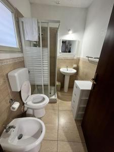 a bathroom with a toilet and a sink at House del corso in Palermo