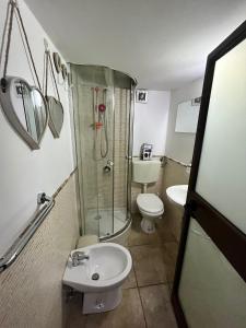 a bathroom with a shower and a toilet and a sink at House del corso in Palermo