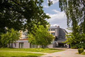 un immeuble d'appartements avec des arbres devant lui dans l'établissement Hotel Prebold, à Prebold