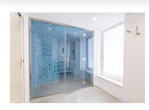 a bathroom with a shower with a glass door at Pietre Bianche in Carovigno
