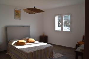 a bedroom with a bed with two pillows on it at Casa di Mare in San-Martino-di-Lota