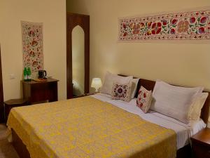 a bedroom with a large bed with two pillows at Hotel Saidkasim with a Terrace in Bukhara