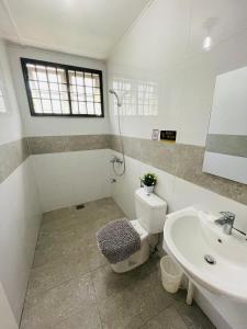 a bathroom with a toilet and a sink at Joyful homestay Miri in Miri