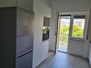 uma cozinha com um frigorífico e uma porta aberta em casa pagliara em Sorrento