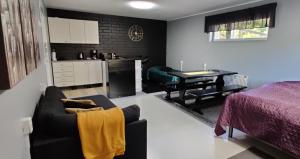 a kitchen and a living room with a couch and a table at Room by Lake 10 minutes from Tampere centrum in Lempäälä