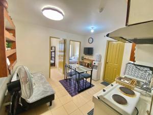 a kitchen with a sink and a table in a room at 2BR within the heart of the City with WIFI and Netflix in Davao City